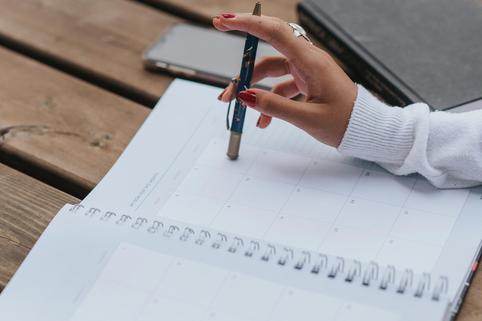 Woman about to write on calendar